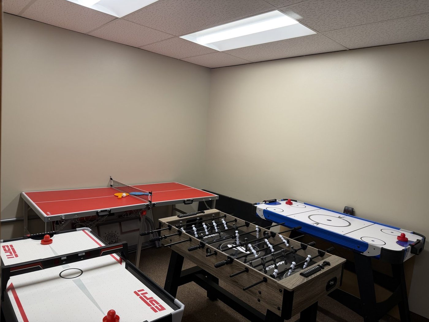 AMAN game room with ping pong, foosball, and air hockey